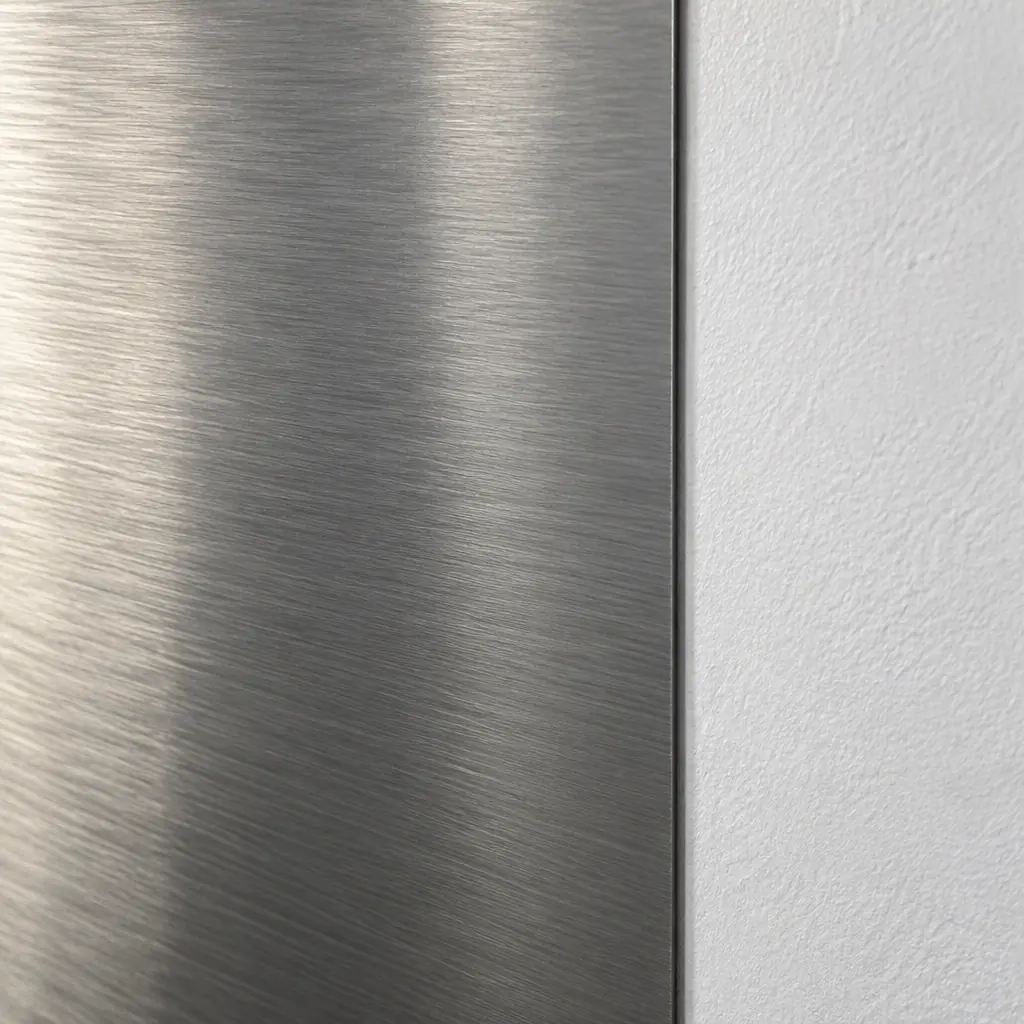 Photorealistic close-up of a plain brushed steel panel with soft reflections, no text, no logos